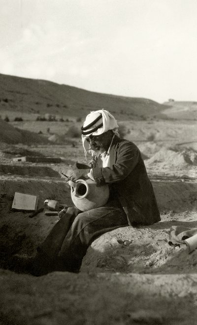 John Garstang at Jericho studying a Middle Bronze Age jug from c.1800 BC by English Photographer